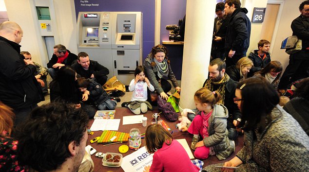 Children play while parents catch up in bank converted to playcenter